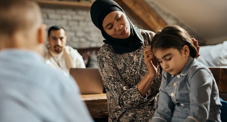 African American Muslim woman and her family enjoying in their time together at home.